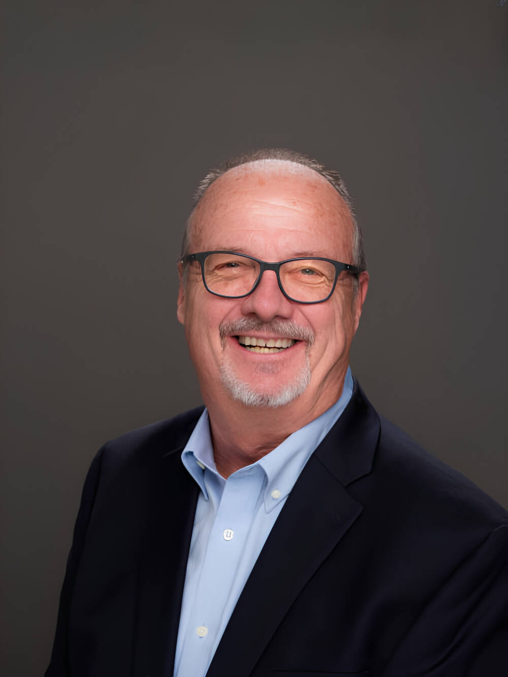 Paul Hillman smiling for a professional photo